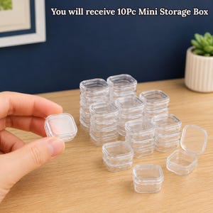Peut inclure: Un ensemble de 10 mini boîtes de rangement carrées et transparentes avec couvercles à charnières. Les contenants sont en plastique transparent, présentés empilés et individuellement, avec une boîte tenue pour montrer sa petite taille.