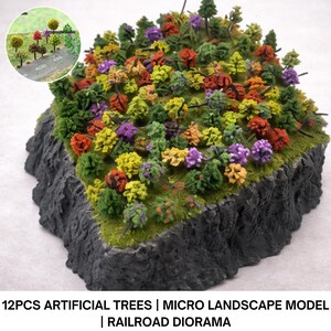 Puede incluir: Un diorama en miniatura con una base rocosa y una variedad de árboles artificiales coloridos. Los árboles son verdes, amarillos, naranjas, rojos y morados. El texto en la parte inferior dice "12PCS ARTIFICIAL TREES | MICRO LANDSCAPE MODEL | RAILROAD DIORAMA."