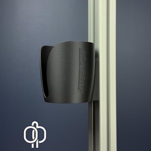 May include: A black cup holder with the text "iRacing" embossed on the side. The cup holder is mounted on a vertical metal support. The background is a solid dark blue.