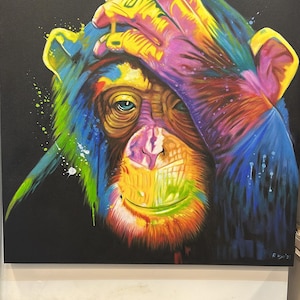 May include: A vibrant, colorful painting of a chimpanzee covering its eyes with a hand. The artwork features a black background and a rainbow of colors, including yellow, blue, green, and purple, creating a striking visual effect. The painting is signed.