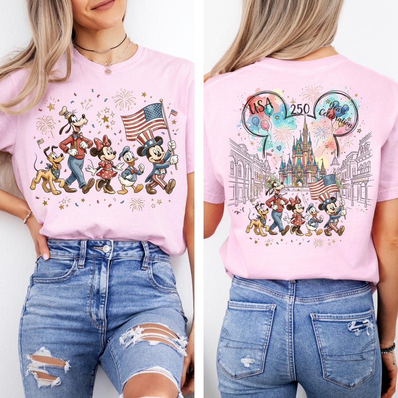 May include: A light pink t-shirt featuring a graphic of Disney characters including Mickey Mouse, Minnie Mouse, Donald Duck, Goofy, and Pluto. The front shows them marching with a US flag. The back displays a castle, fireworks, and the text USA 250 Years Celebration.