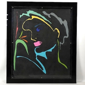 May include: Abstract art print featuring a woman's profile with colorful outlines on a black background. The artwork includes pink lips, blue eyes, and accents of yellow, green, and turquoise. The piece is framed in a black frame.