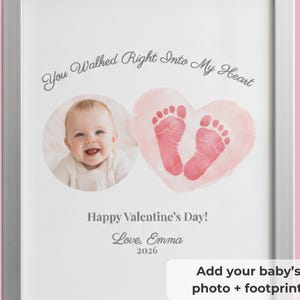 May include: A framed print featuring a baby's photo and footprints within a heart shape. The text includes "You Walked Right Into My Heart", "Happy Valentine's Day!", "Love, Emma", and "2026". The frame is silver.