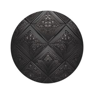 May include: A circular, black decorative piece with an ornate, embossed design. The pattern incorporates geometric shapes and floral elements, producing a textured, three-dimensional appearance. The overall style is dark and sophisticated.
