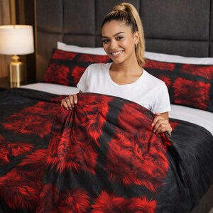 May include: A black and red floral patterned comforter set on a bed. The comforter, pillowcases, and bedspread feature a bold, abstract floral design in shades of red and black. The bedding is displayed on a bed with a white sheet and a dark headboard.
