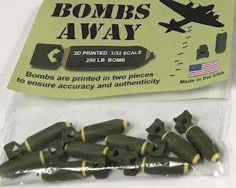 May include: A collection of 3D-printed model bombs in a clear plastic bag. The bombs are olive green with yellow accents. The packaging reads "BOMBS AWAY" and "3D PRINTED 1/32 SCALE 250 LB BOMB". Made in the USA.