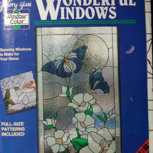 May include: A blue book cover titled "WONDERFUL WINDOWS" displays a stained glass design of butterflies and flowers. The cover also includes the text "Window Color" and "FULL-SIZE PATTERNS INCLUDED".