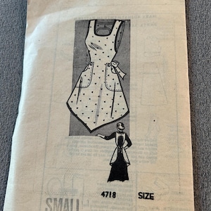 May include: Vintage sewing pattern for a small apron. The pattern illustration shows a white apron with black heart-shaped polka dots, pockets, and a bow. The pattern number is 4718.