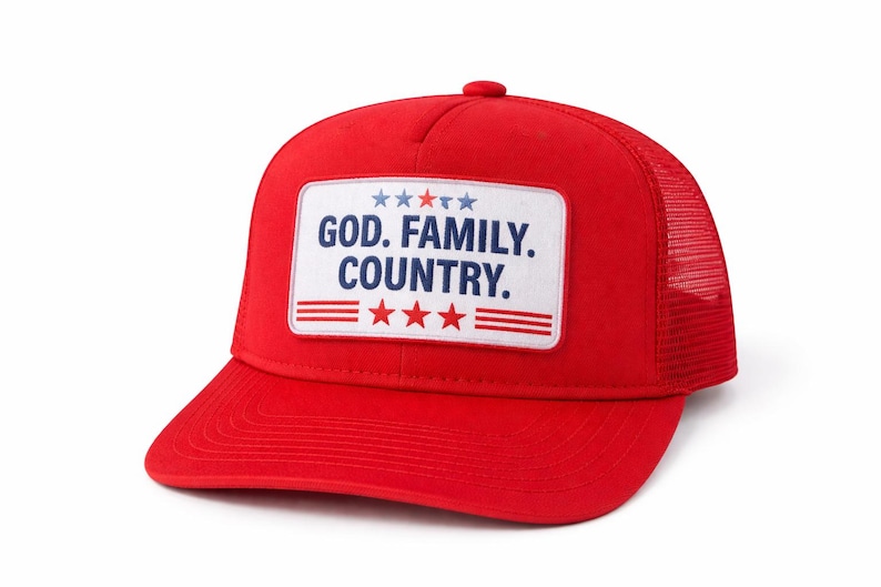 May include: A red trucker hat with a white patch featuring the text "GOD. FAMILY. COUNTRY." The patch includes blue stars and red stripes. The hat has a mesh back and a curved brim.