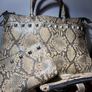 May include: A set of three ceramic mugs with a speckled, matte finish. The mugs are in shades of cream, light gray, and dark gray. Each mug has a simple, minimalist design, perfect for coffee or tea.