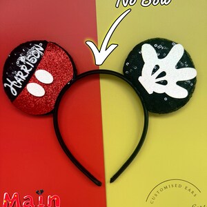 May include: Black headband with Mickey Mouse ears. One ear is red with white polka dots and the name "Harrison". The other ear is black with a white Mickey Mouse hand. The text "No Bow" is above the ears.