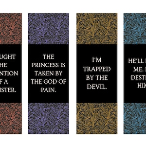 May include: Four rectangular bookmarks with floral patterned backgrounds in red, purple, yellow, and blue. Each bookmark has a black bar with white text: "I CAUGHT THE ATTENTION OF A MONSTER."