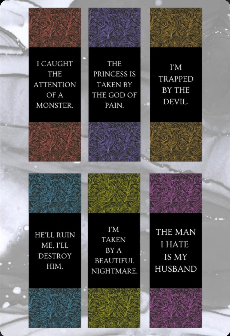 May include: Set of six bookmarks with dark backgrounds and floral patterns in red, purple, and yellow. Each bookmark has a black banner with white text, including phrases like "I Caught the Attention of a Monster" and "The Man I Hate Is My Husband."