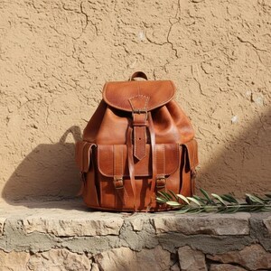 Handmade brown leather backpack with vintage design and front buckle pockets, rustic travel rucksack for work, college, hiking and everyday carry