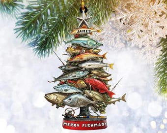 May include: A Christmas tree ornament shaped like a tree made of various fish. The ornament has a star at the top with the name "JAMES". The base of the ornament reads "MERRY FISHMAS!" and "PERSONALIZED DESIGN".