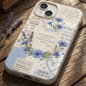 May include: A white phone case with a floral design featuring blue flowers and lavender sprigs. The case includes inspirational quotes and religious text, such as "God is so much bigger than..." and "Jesus is the way."