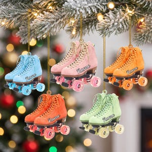 May include: Five hanging roller skate ornaments in light blue, pink, orange, dark orange, and light green. Each skate features a lace-up design, black wheels, and the word Name printed in a cursive script on the side of the boot.