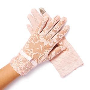 May include: A pair of pink lace gloves with a bow detail. The gloves are made of delicate lace and have a soft, feminine look.