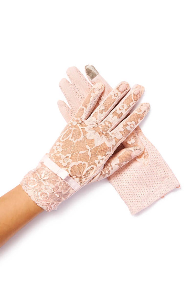 May include: A pair of pink lace gloves with a bow detail. The gloves are made of delicate lace and have a soft, feminine look.