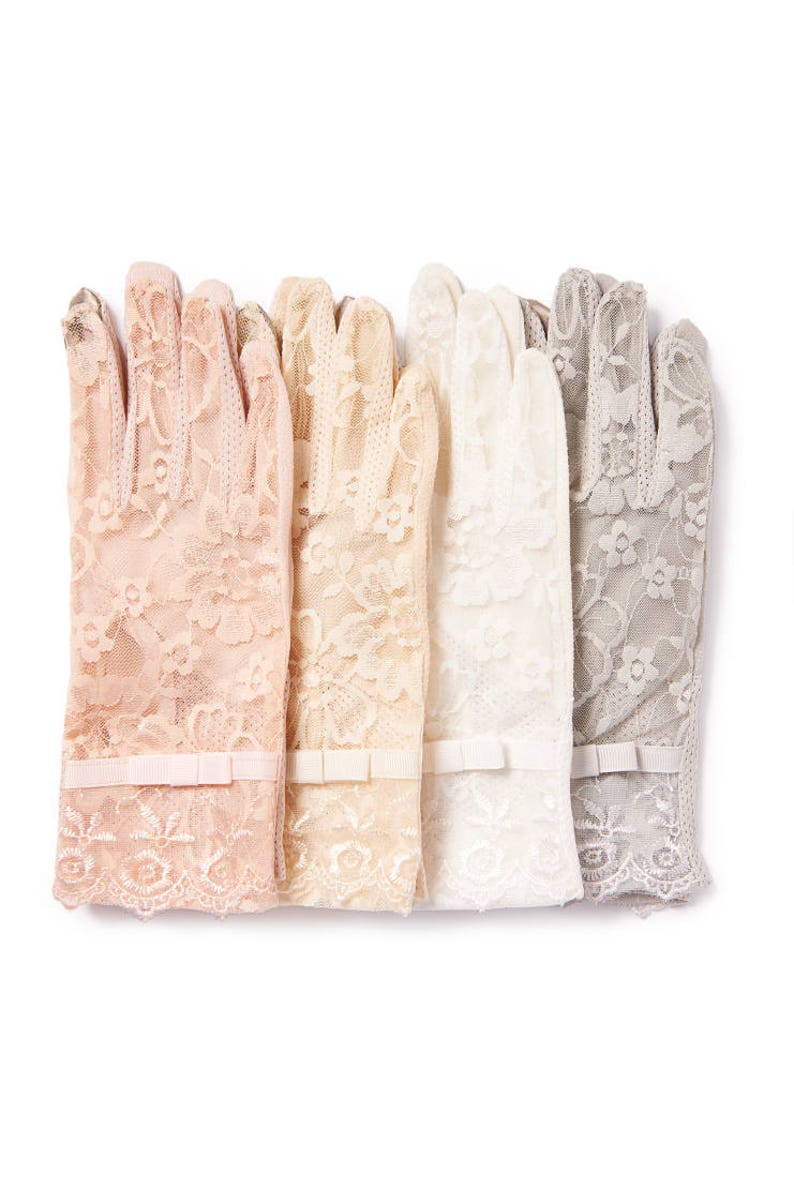 May include: Four pairs of delicate lace gloves in different shades of beige, cream, and gray. Each glove has a small white bow at the wrist.