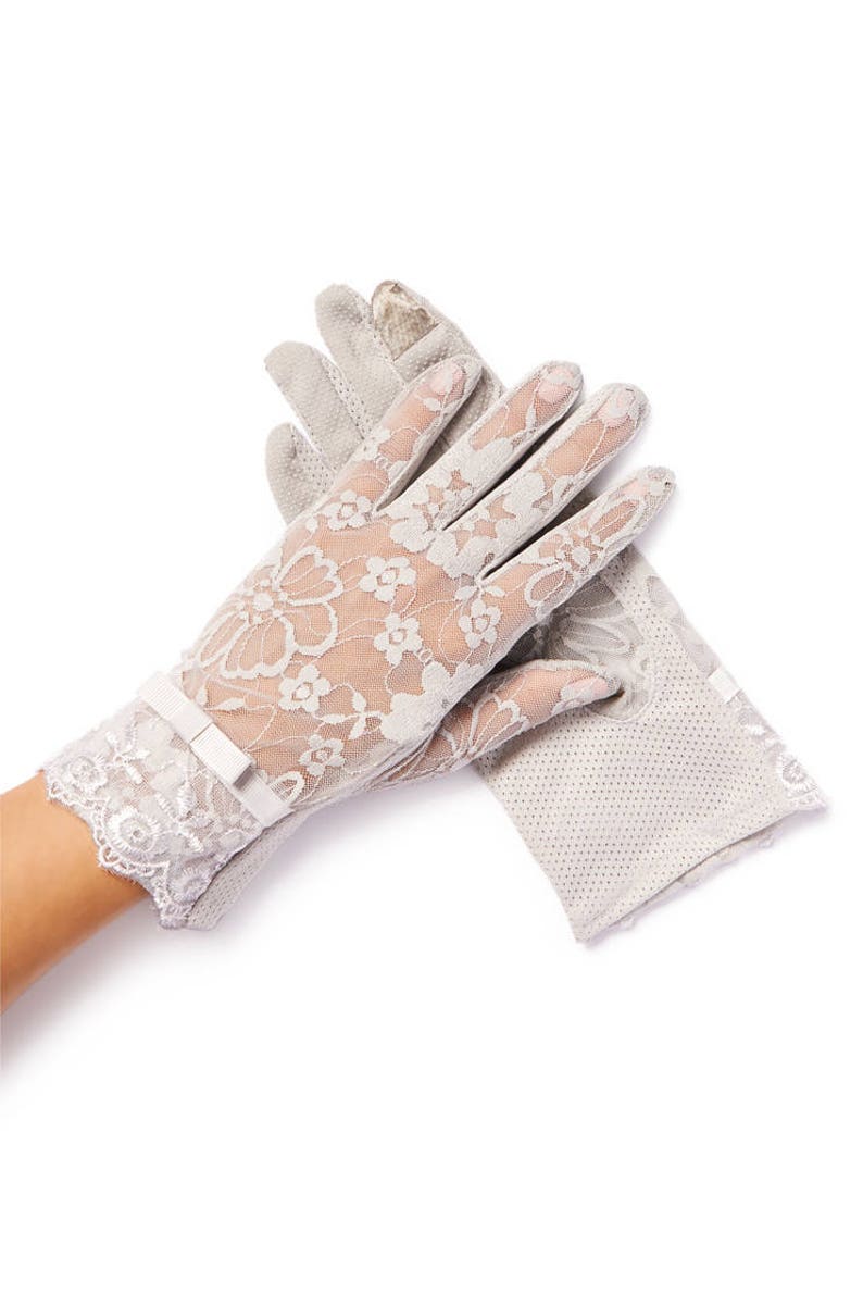 May include: A pair of gray lace gloves with a floral pattern. The gloves have a bow on the wrist and are made of a sheer fabric.