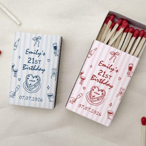 May include: A white ceramic mug with a black handle and the text "But First, Coffee" in a handwritten style. The mug is on a white surface. The mug is approximately 4 inches tall.