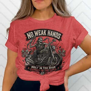 Red t-shirt with skull rider on motorcycle graphic and text.