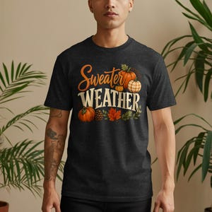 Dark t-shirt with "Sweater Weather" text and fall pumpkin graphics.