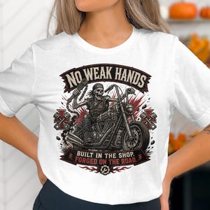 Skeleton biker on motorcycle with "No Weak Hands" text.