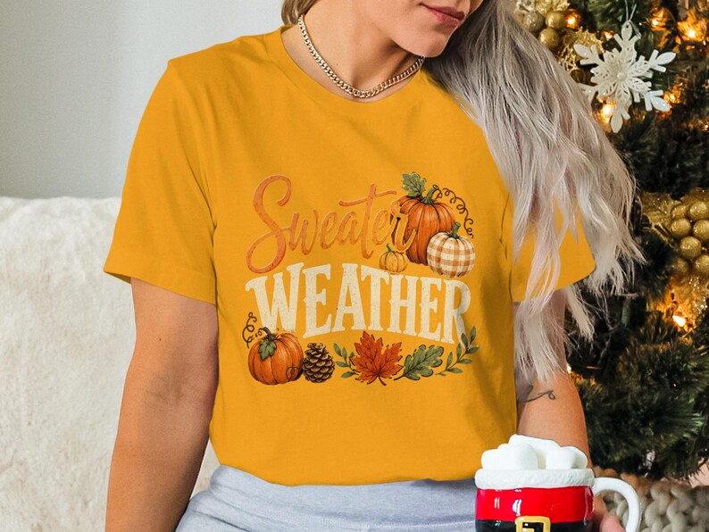 Yellow t-shirt with "Sweater Weather" text and pumpkin autumn graphics.