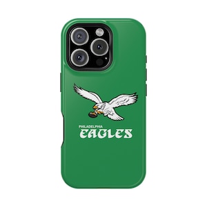 May include: Green phone case with the Philadelphia Eagles logo. It shows a white eagle with outstretched wings and a football, plus the team name in white. The case has a glossy finish.