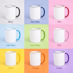 May include: A collection of white ceramic mugs with colored handles and rims. The mugs are available in black, navy blue, red, light blue, lime green, pink, yellow, orange, and purple. Each mug has a white body with a colored handle and rim.