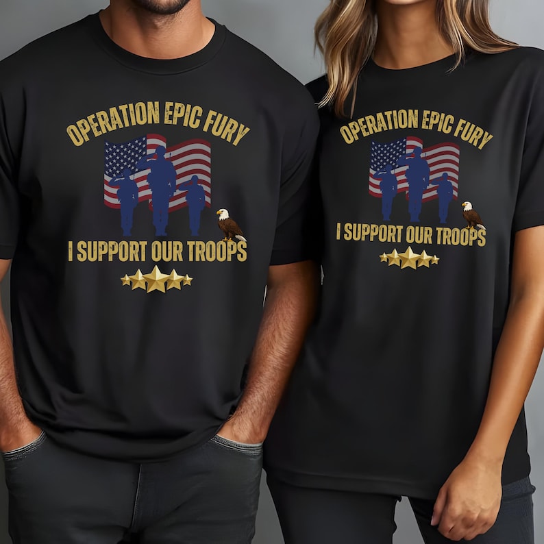 May include: Black t-shirts with the text "OPERATION EPIC FURY" above an American flag graphic and the words "I SUPPORT OUR TROOPS". The design includes silhouettes of soldiers, an eagle, and gold stars.