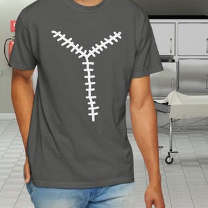 May include: Dark gray t-shirt featuring a white zipper design. The graphic is a stylized Y-shaped zipper, with the zipper teeth in white. The shirt is a crew neck and short-sleeved.