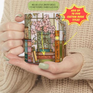 May include: White ceramic mug featuring a floral and book design with the text "Add up to five custom book titles". The mug has a flat, smooth surface. The design includes pink flowers and the text "Custom Title #1", "Custom Title #4", and "Custom Title #5".