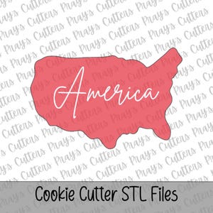 May include: A coral-colored cookie cutter shaped like the map of the United States of America. The word America is written in white cursive script across the center of the shape. The background features a repeating watermark of the text Pray's Cutters.