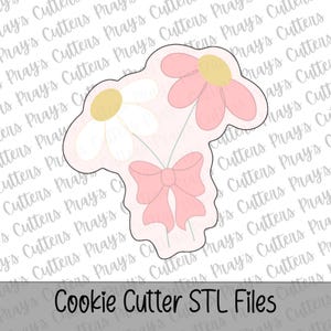 May include: A cookie cutter shaped like a bouquet of two flowers with a bow. One flower has white petals and a yellow centre, while the other has pink petals and a yellow centre. The stems are tied together with a pink bow at the bottom.