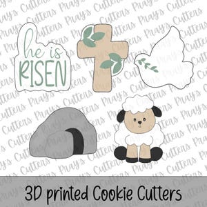May include: A selection of 3D printed cookie cutters. The shapes include a cross, a dove, a tomb, and a sheep. One cutter features the text "he is RISEN". The words "3D printed Cookie Cutters" are printed at the bottom.