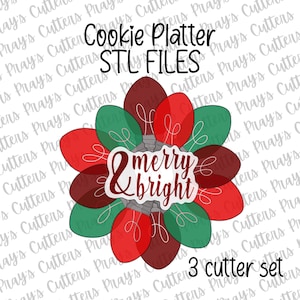 May include: A festive cookie cutter set featuring a design of Christmas lights in red and green, with the words "& merry & bright." The text "Cookie Platter STL FILES" and "3 cutter set" are also visible.