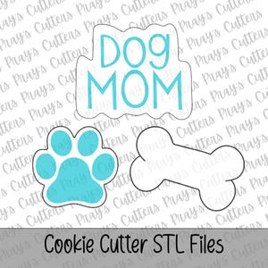 Peut inclure: Ensemble de découpoirs à biscuits sur le thème des chiens. L'ensemble comprend une empreinte de patte, un os et un découpoir avec l'inscription "Dog Mom" en bleu sarcelle. Le texte "Cookie Cutter STL Files" est en bas.