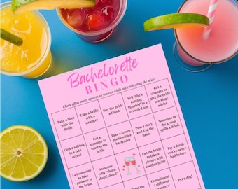 May include: A pink Bachelorette Bingo game card with various tasks to complete. The card is surrounded by three cocktails, garnished with lime slices. The drinks are pink, yellow, and red.