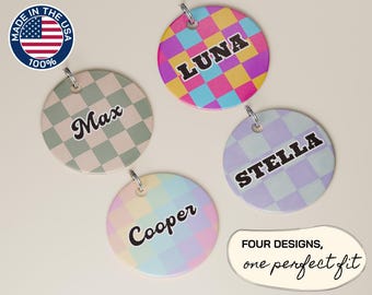 May include: Four colorful pet tag designs with names Luna, Max, Stella, and Cooper. Each tag has a unique checkered pattern in pastel colors. The tags are round with a silver ring for attachment. The text "FOUR DESIGNS, one perfect fit" is also visible.