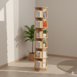 May include: A light wood, rotating bookshelf with multiple shelves. The shelves hold books and decorative items. The bookshelf is cylindrical and stands on short, rounded legs. A potted plant sits nearby.