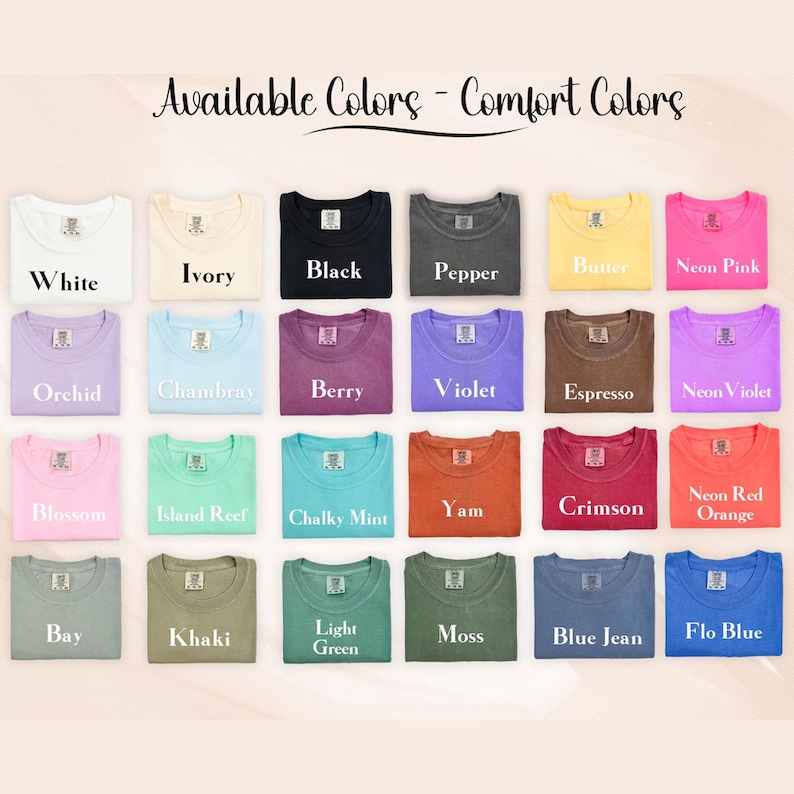 May include: A display of folded t-shirts in various colors, including white, black, and pink. The text "Available Colors - Comfort Colors" is at the top, with color names like "Orchid" and "Chambray" below each shirt.