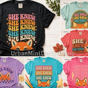 May include: A collection of six short-sleeve t-shirts in black, light green, red, purple, teal, and pink. Each shirt features a graphic print of a fox face and the repeated text 'SHE KNEW' in various retro-inspired fonts, colors, and layouts.