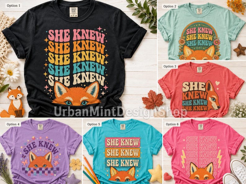 May include: A collection of six short-sleeve t-shirts in black, light green, red, purple, teal, and pink. Each shirt features a graphic print of a fox face and the repeated text 'SHE KNEW' in various retro-inspired fonts, colors, and layouts.