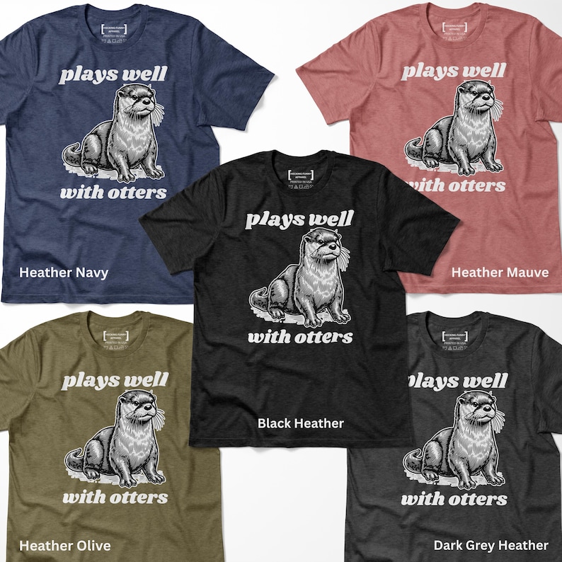 May include: A collection of short-sleeved t-shirts in various colors, including navy, black, and olive green. Each shirt features a graphic of an otter with the text "plays well with otters". The shirts are made of a soft, heathered fabric.