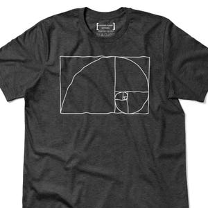 May include: Dark gray t-shirt featuring a white graphic of the golden ratio spiral. The shirt has a crew neck and short sleeves. The text "HECKING FUNNY APPAREL PRINTED IN USA" is printed at the top.
