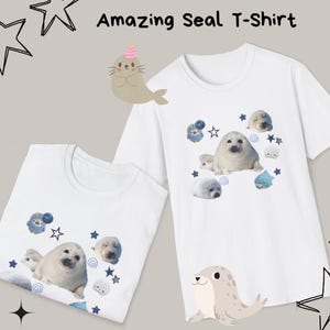 May include: White t-shirts with a seal graphic. The shirts feature a cute seal illustration with blue accents, stars, and the text "Amazing Seal T-Shirt". The design includes a seal wearing a party hat.