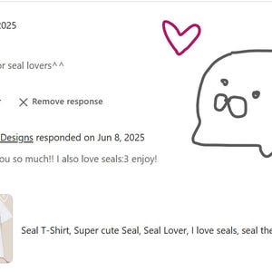 May include: A white t-shirt with a cartoon seal design. The image includes a customer review with five stars and the text "It's a great shirt for seal lovers^^."